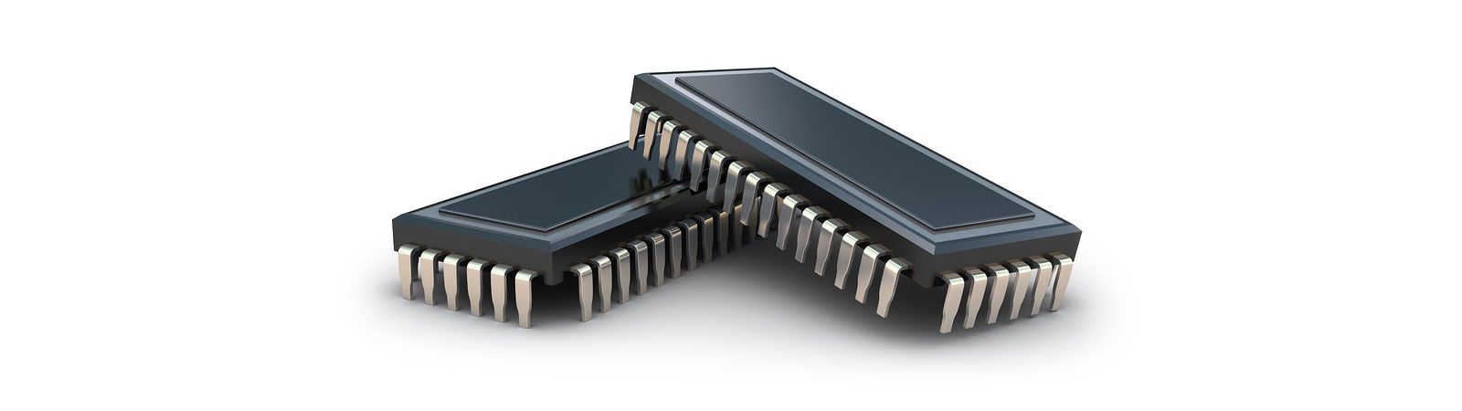 Two black integrated circuit chips with silver pins on a white background